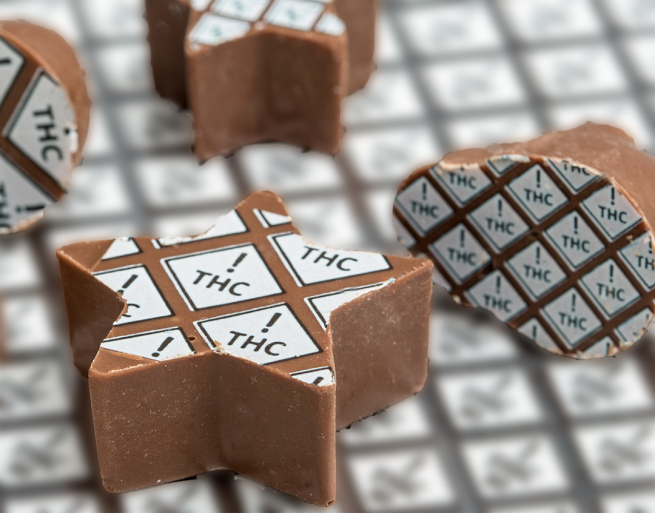 chocolate stars marked with white THC ! diamonds with a blurred background