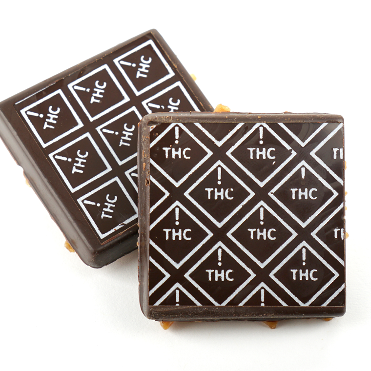 chocolate squares marked with white ! thc diamond symbols