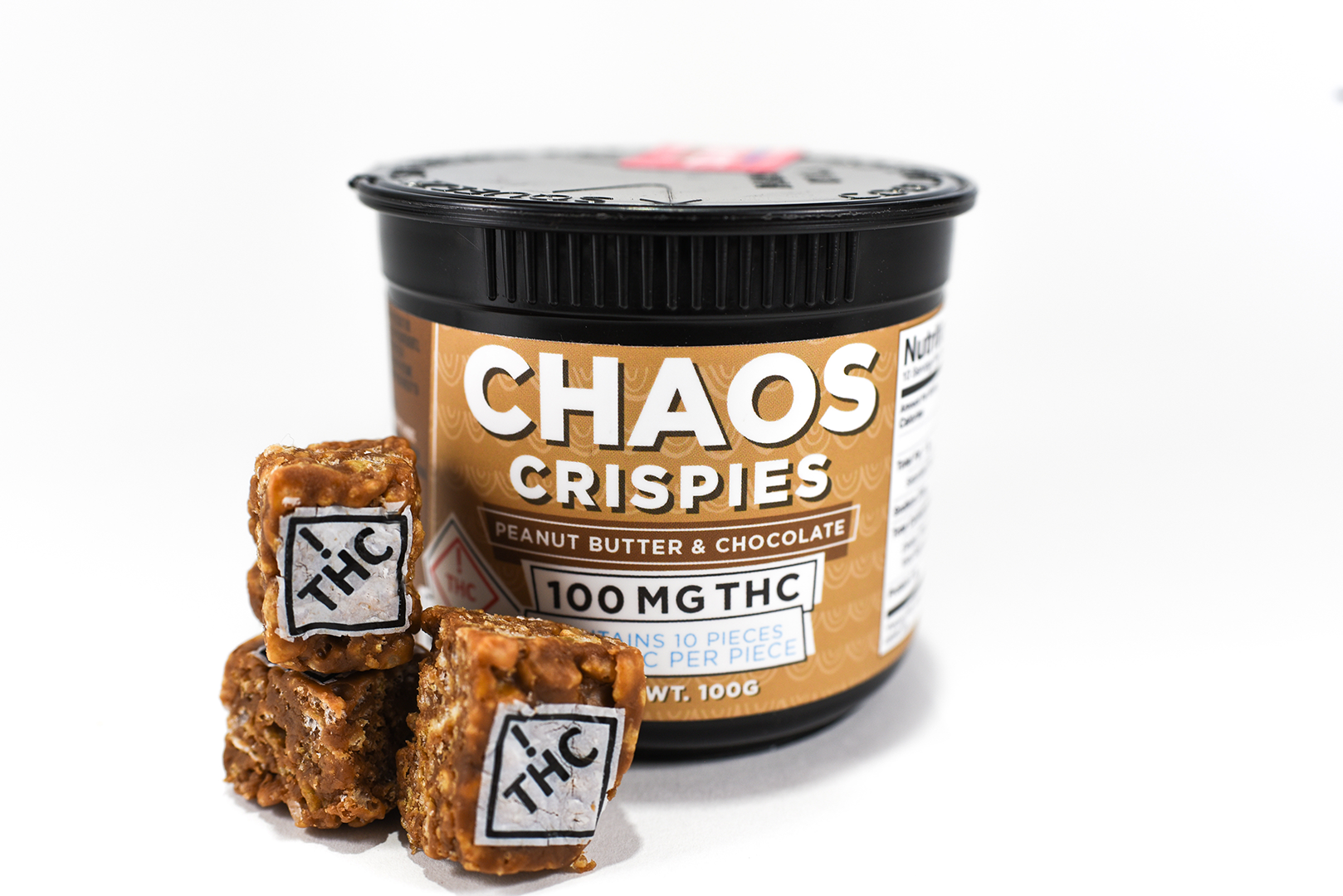 chocolate rice crispy squares with white ! thc diamond symbols imprinted on them next to a container that says "CHAOS CRISPIES"