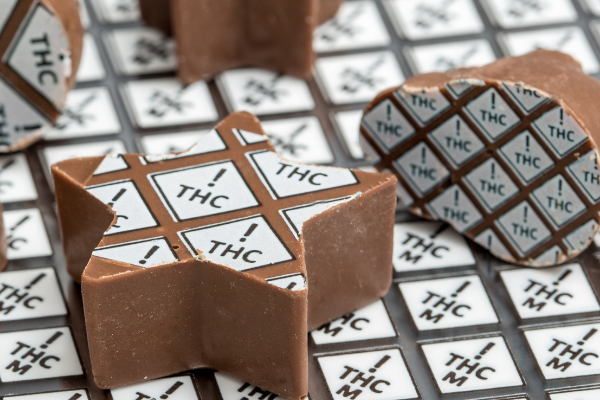 edible transfer sheets with colorado's universal thc symbol for edibles in black and white on chocolates