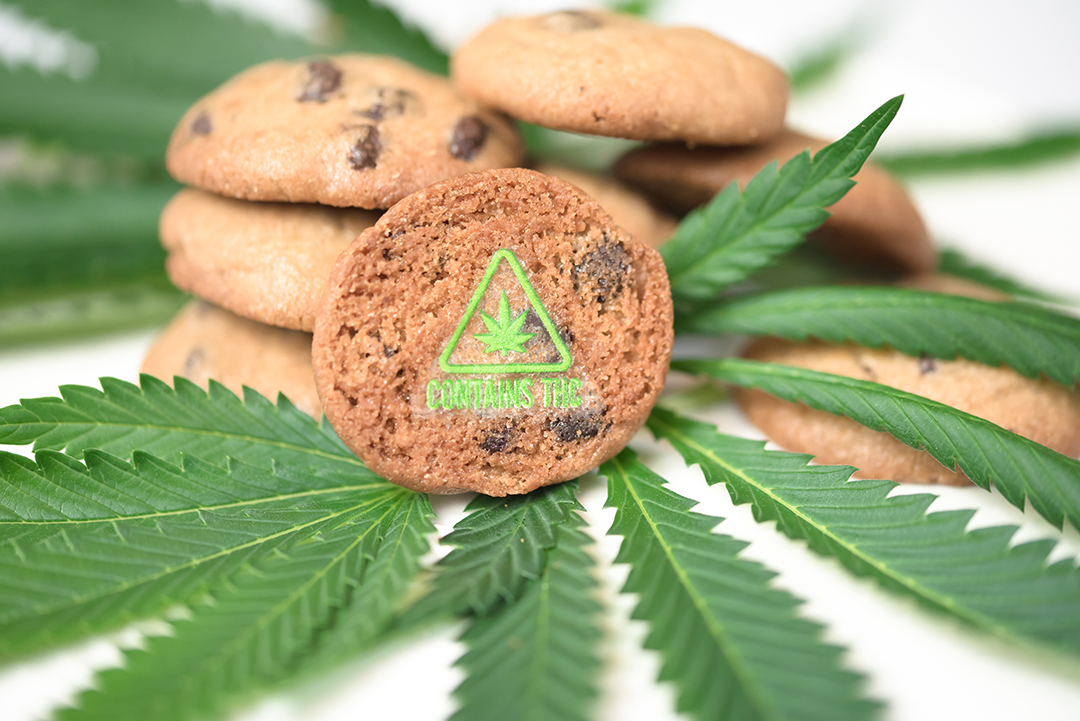 green contains THC symbol target on cookies with cannabis leaves