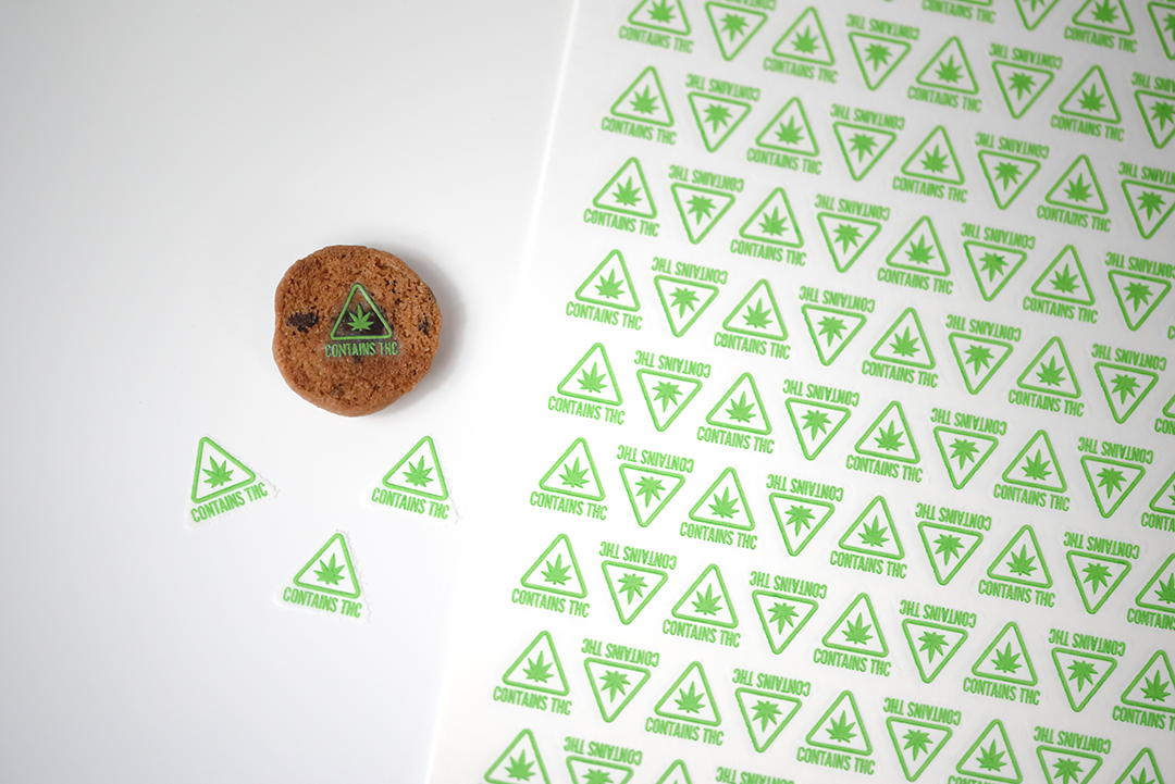 green contains THC symbol target on cookies next to sheet of targets