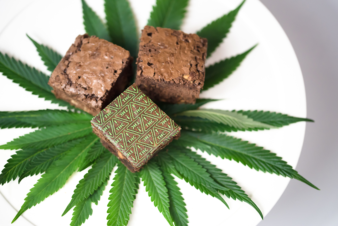 Nevada THC symbol sheets on brownie with cannabis leaves