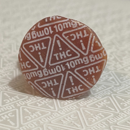 a gummy marked with white 10mg nevada thc symbols